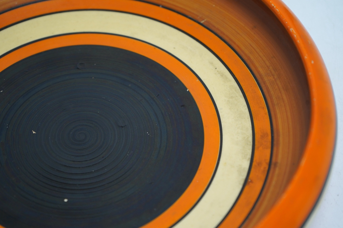 A Clarice Cliff Fantasque shallow dish, 24cm in diameter. Condition - fair